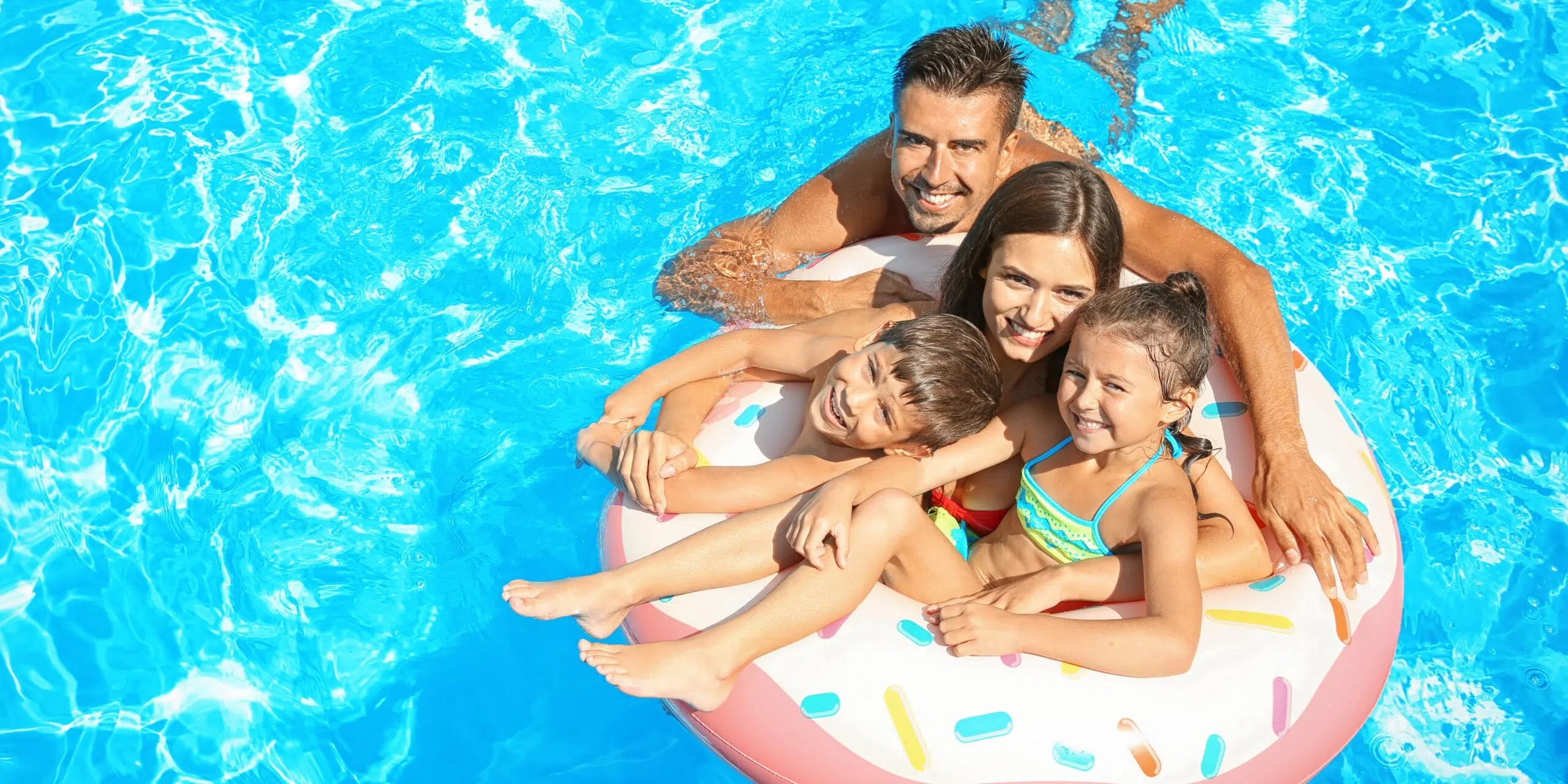 a family floating in pool
