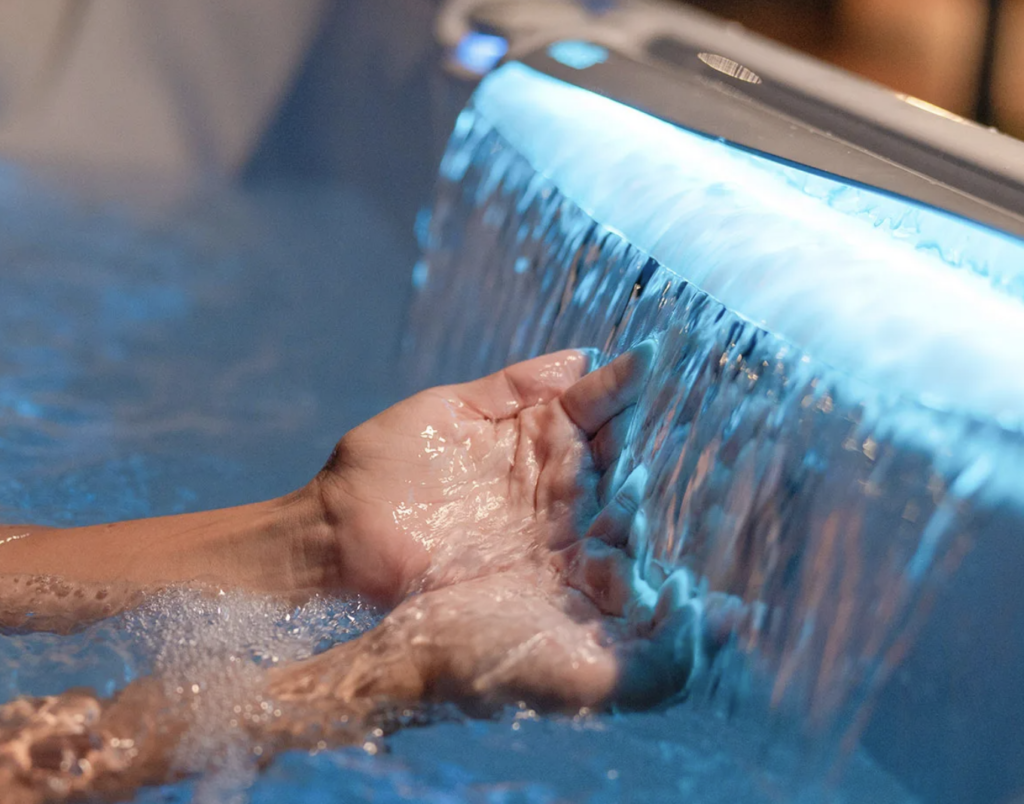 Portable Spas & Hot Tubs At Mr. Pool of Pasco & Crystal River 11 hand under water in Wellis Makalu Life Essential Hot Tub
